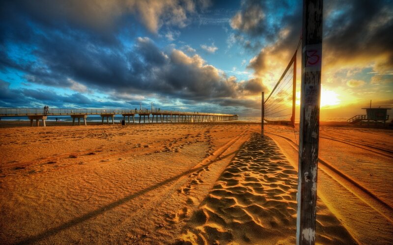 Beach volleyball at sunset