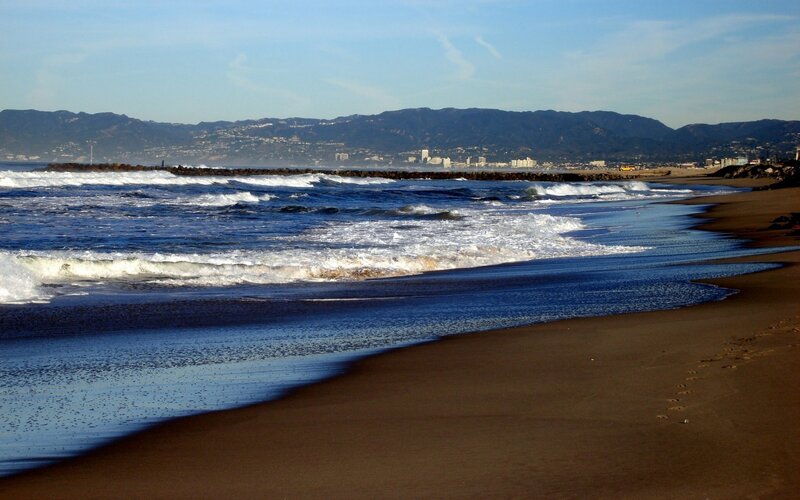 beach waves and distant city