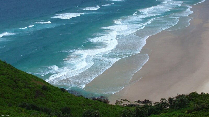 beach waves and green hill