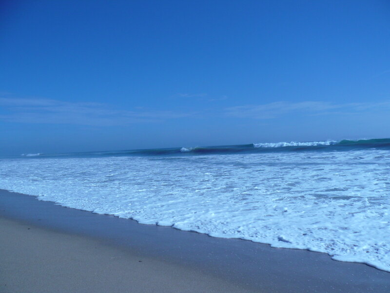 beach waves under blue sky