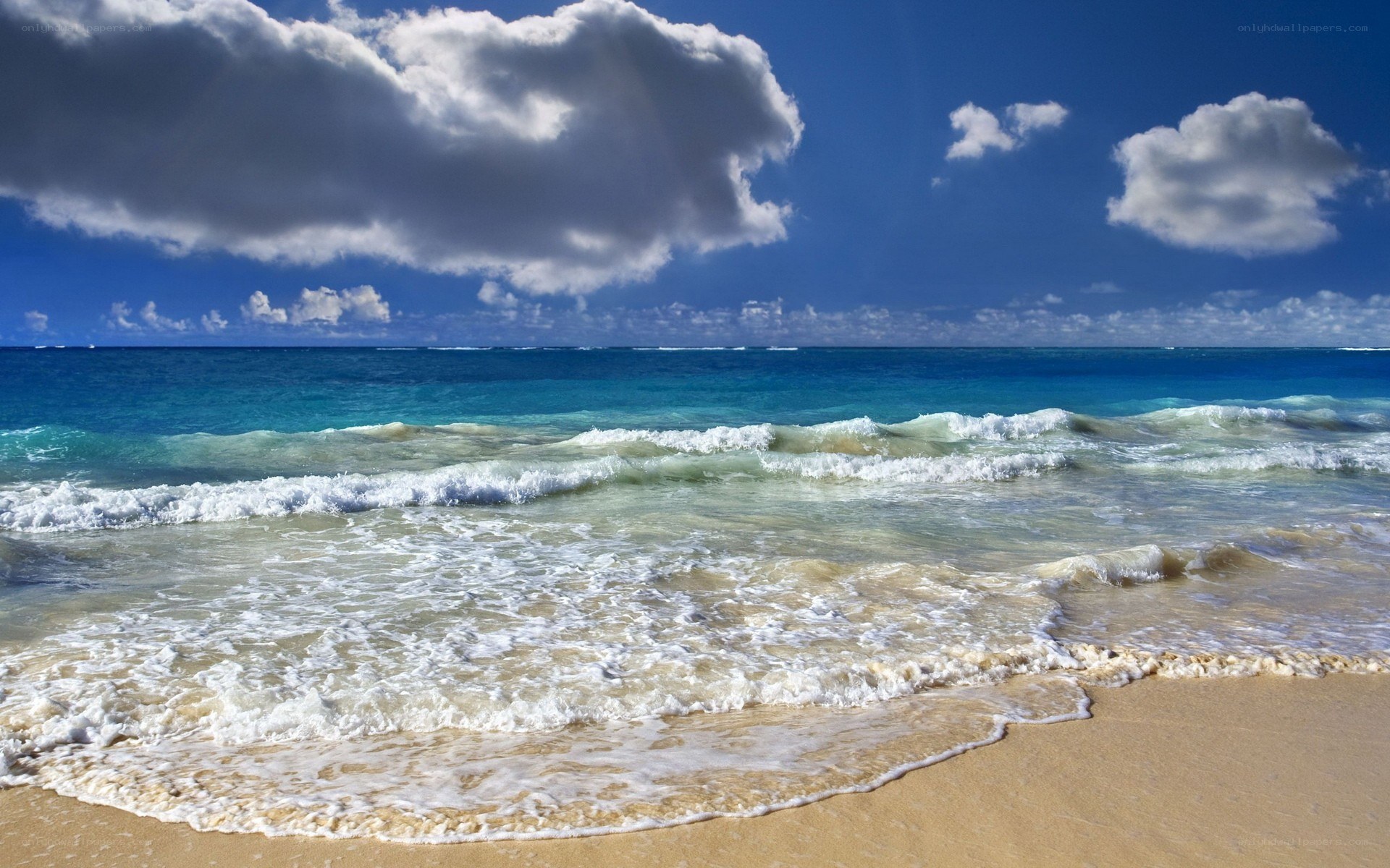 Beach waves under cloudy sky