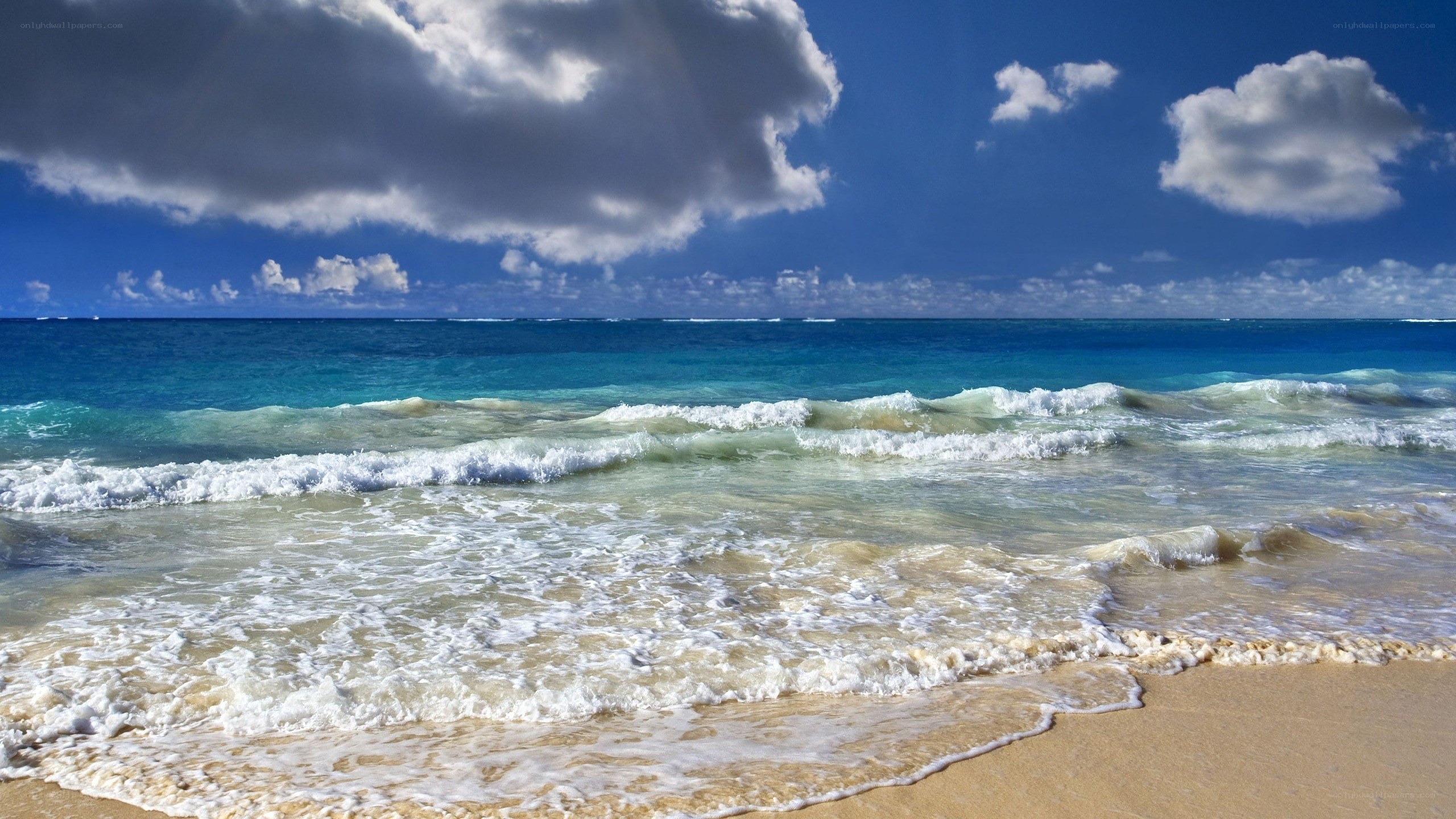 Beach waves under cloudy sky