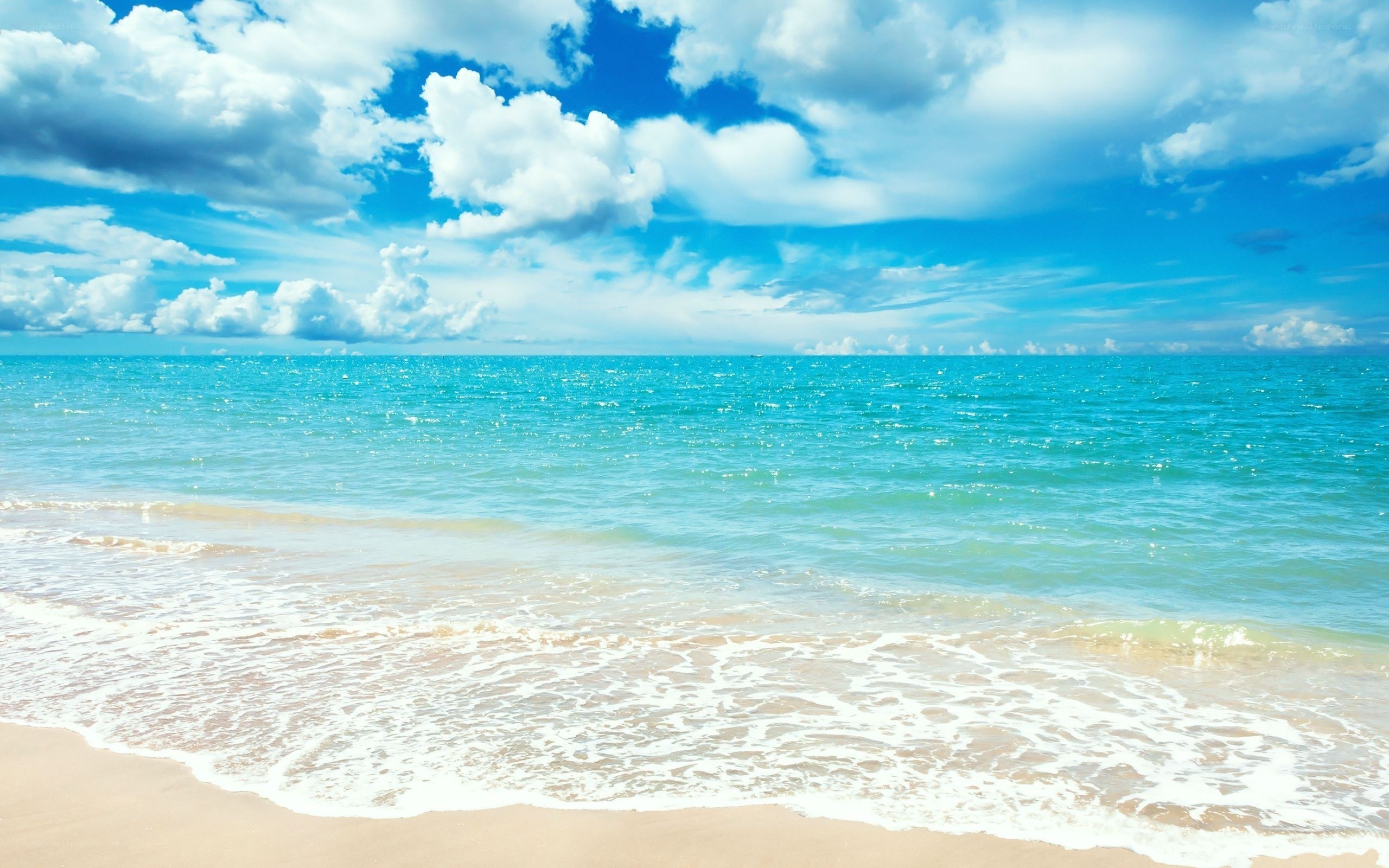 Beach with blue sky and waves