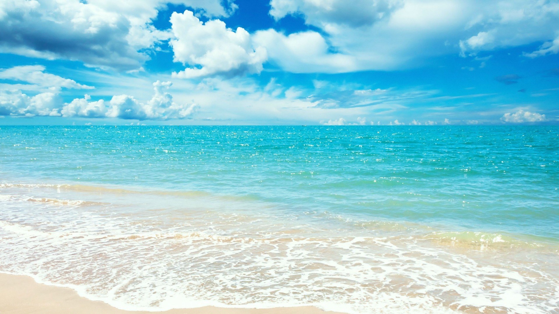 Beach with blue sky and waves