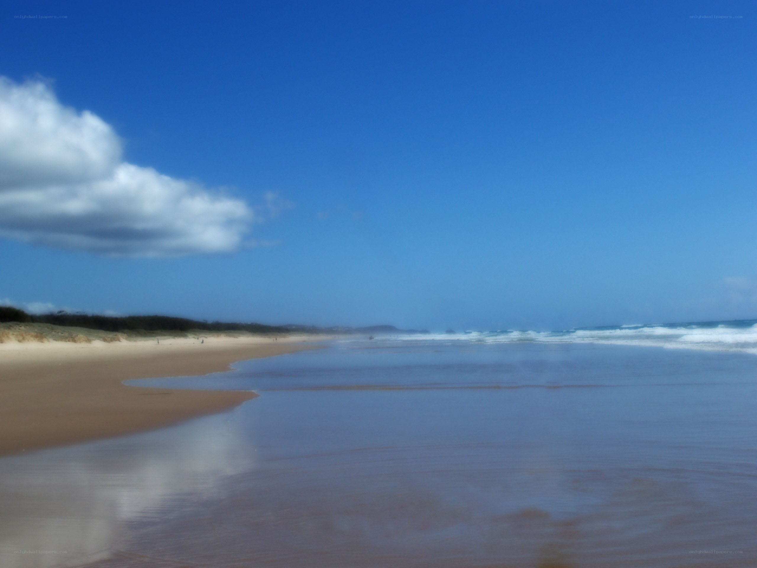 Beach with blue sky and waves