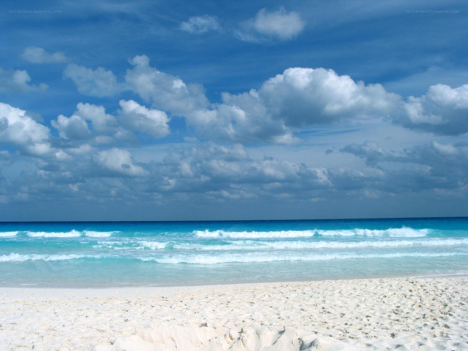 Beach with blue sky and waves