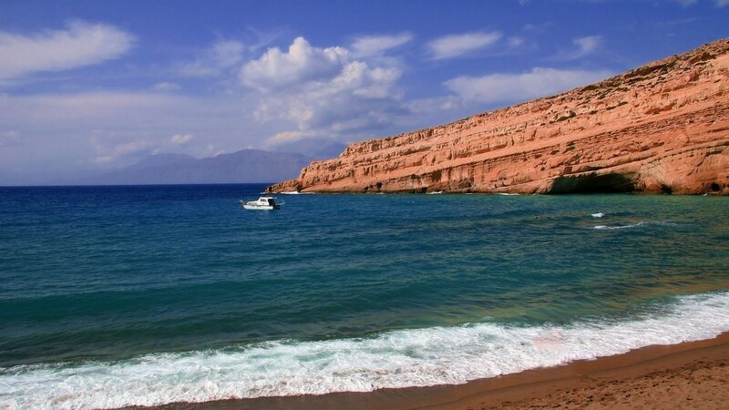 Beach with boat and cliffs