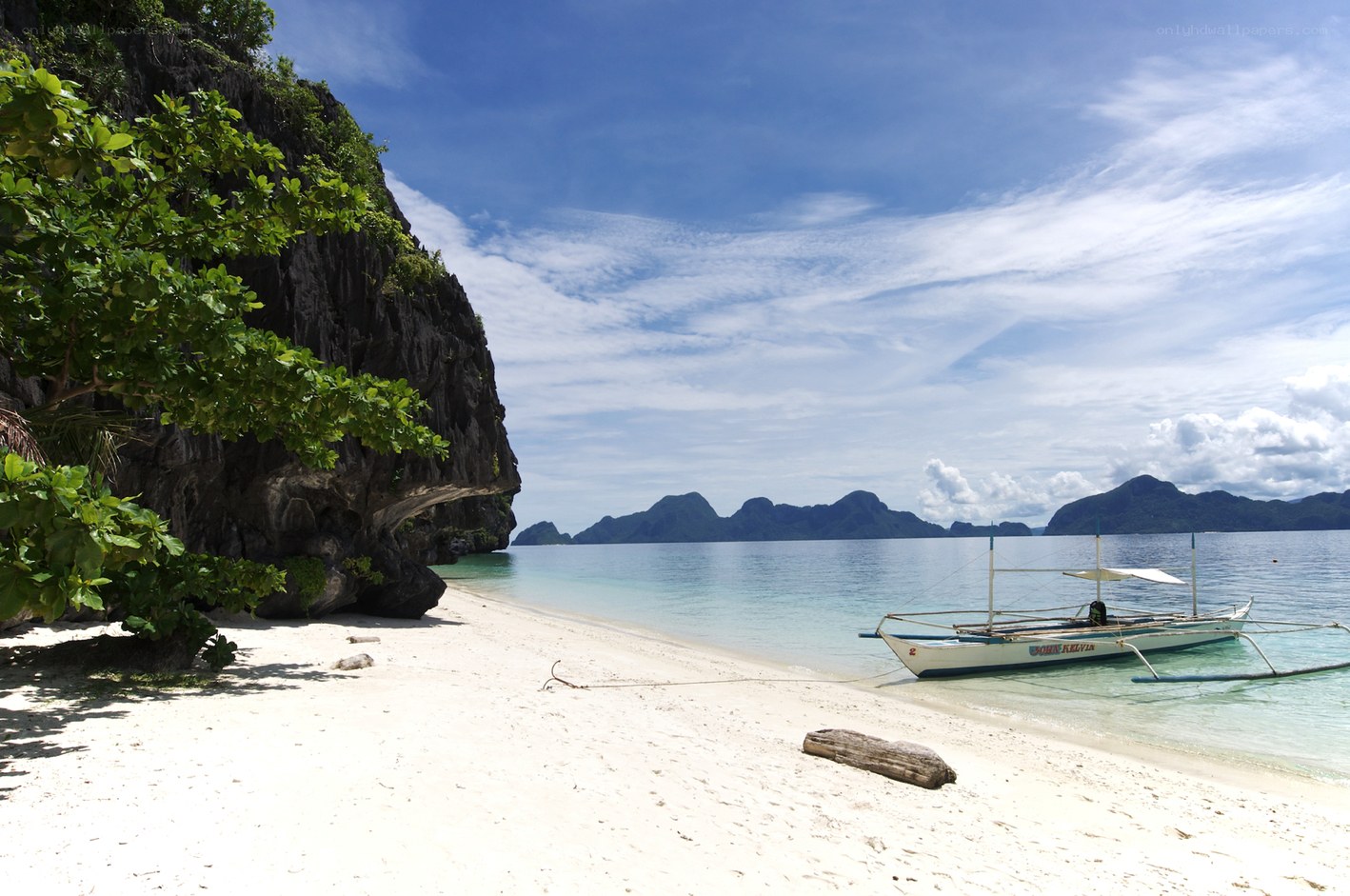Beach with boat and cliffs