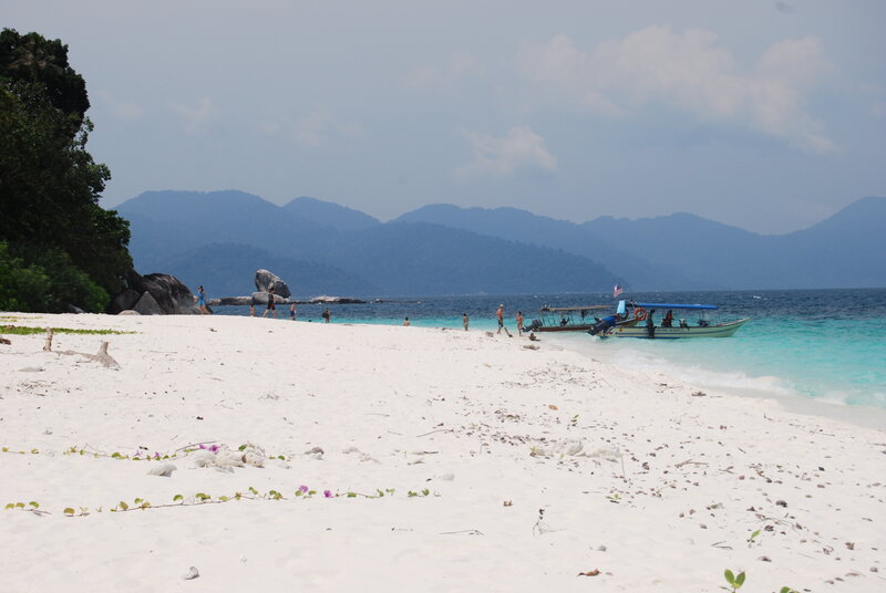 Beach with boat and mountains