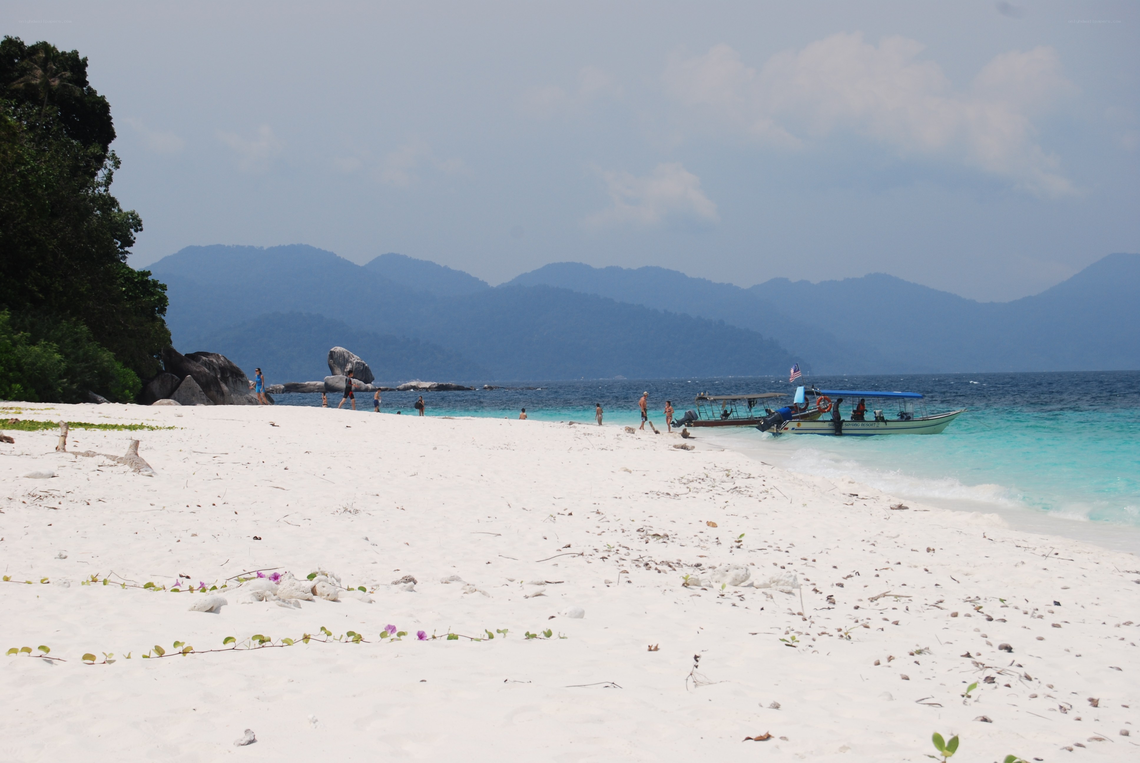 Beach with boat and mountains