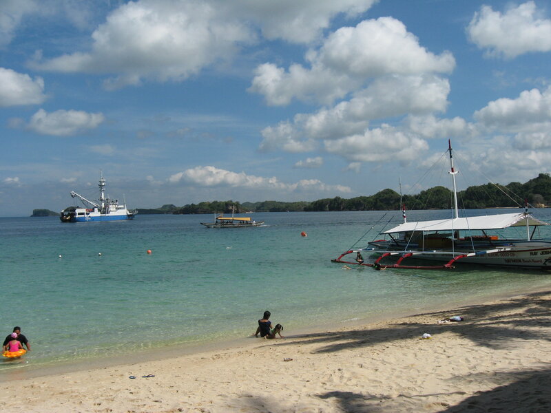 Beach with boats and people