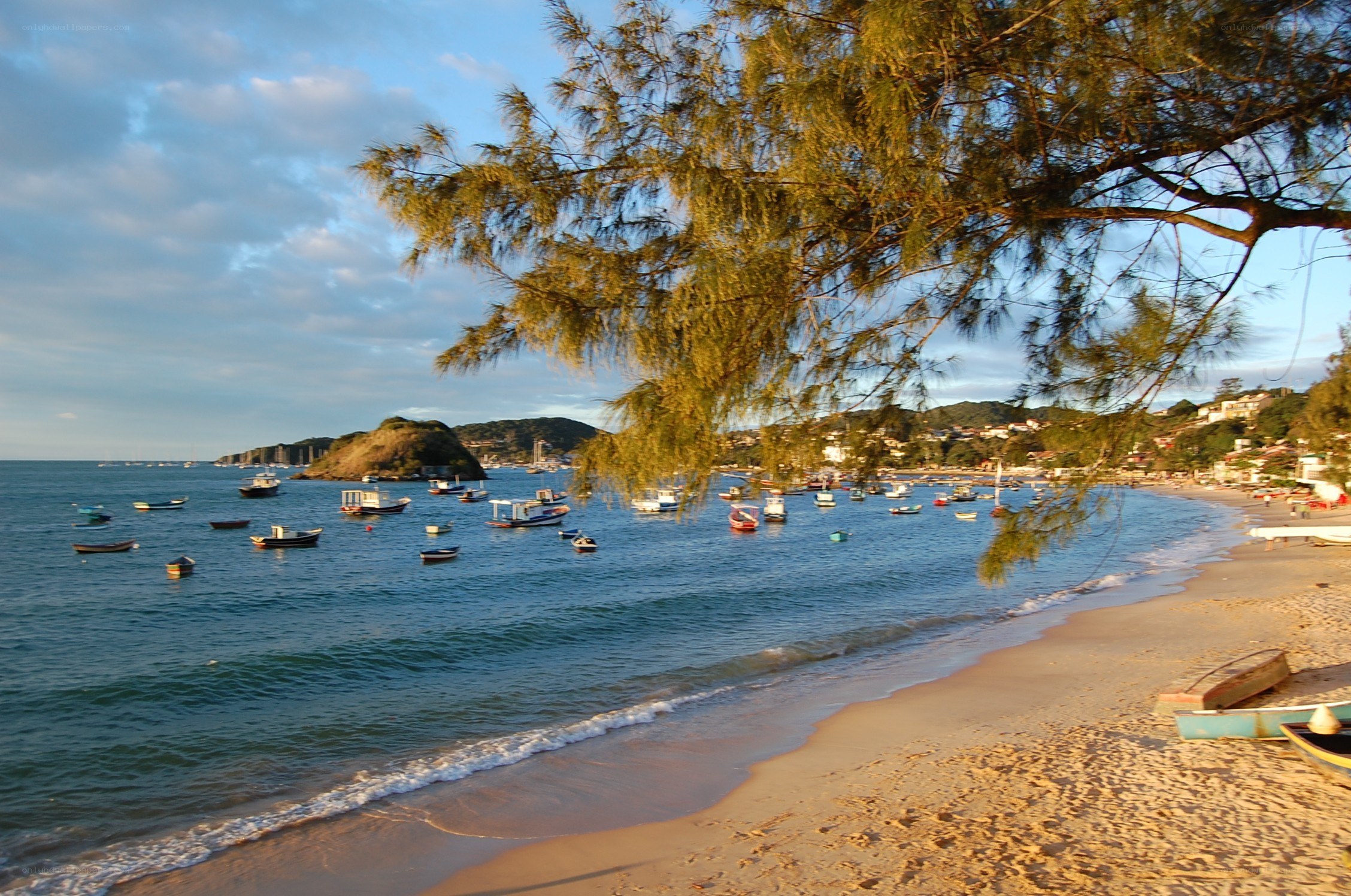 Beach with boats at sunset