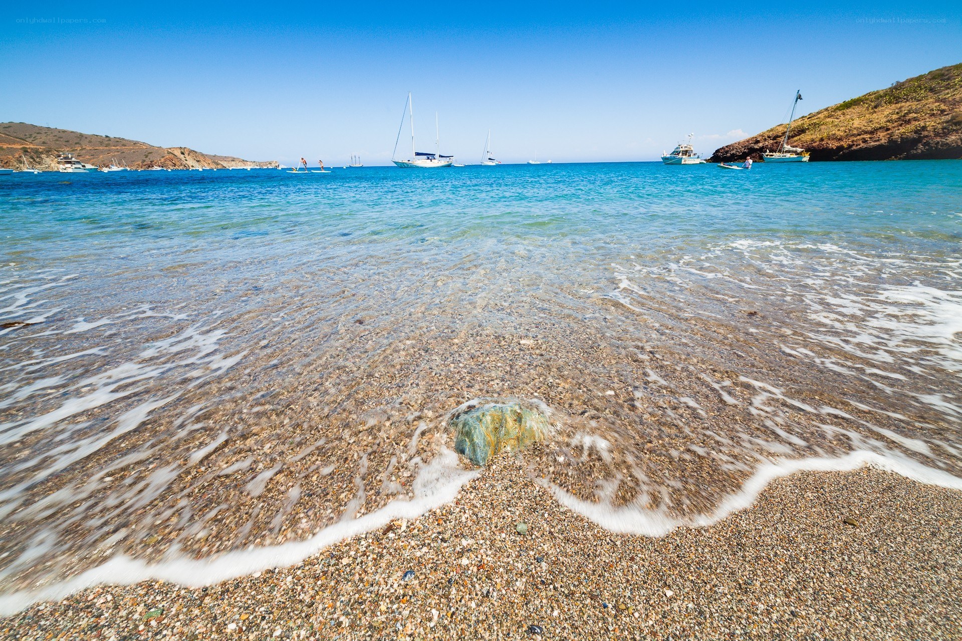 Beach with boats in bay
