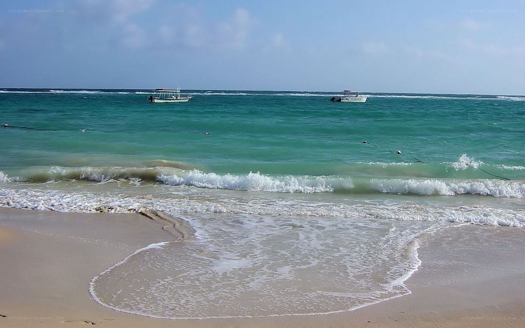 beach with boats in distance