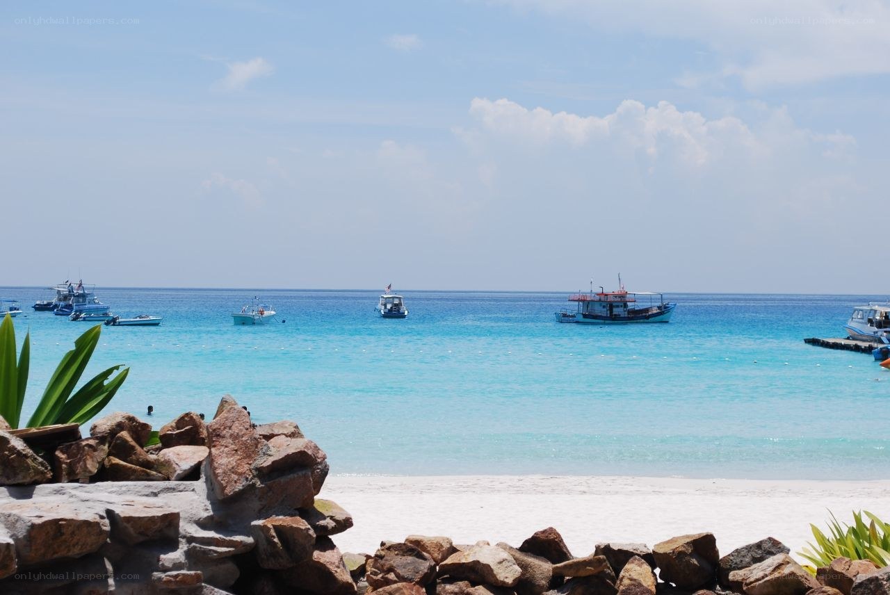 Beach with boats in the sea