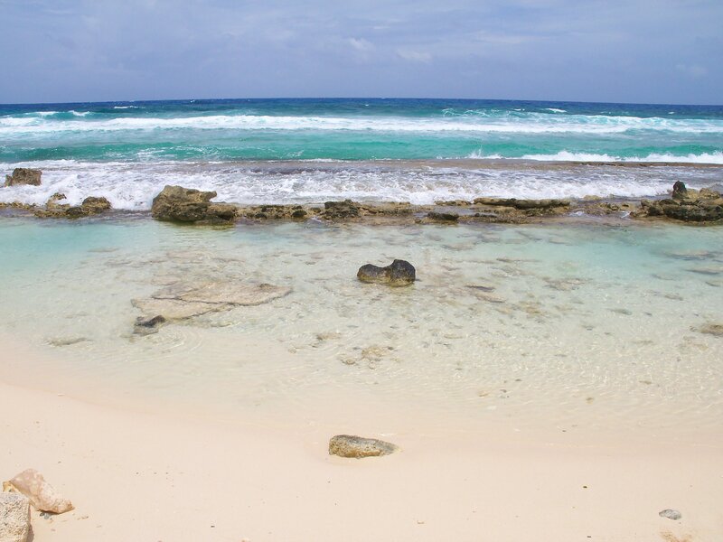 beach with clear water and rocks