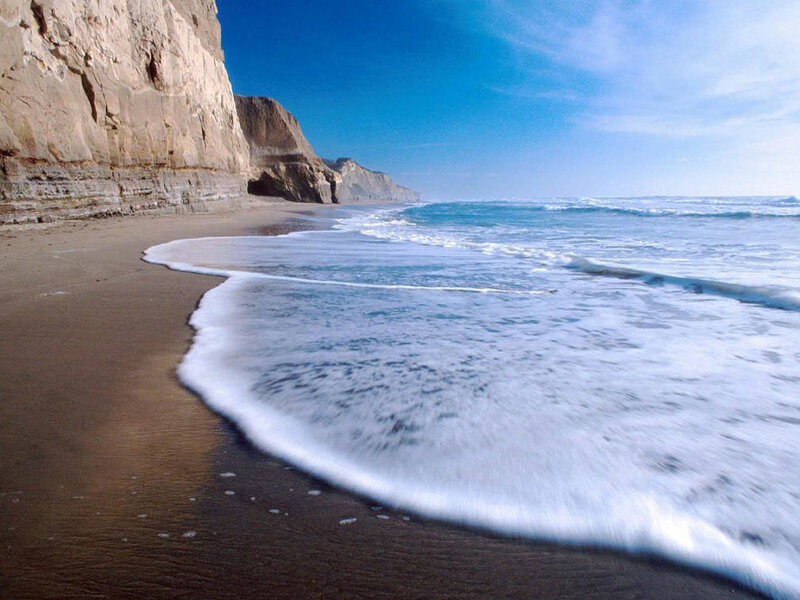 beach with cliffs and waves