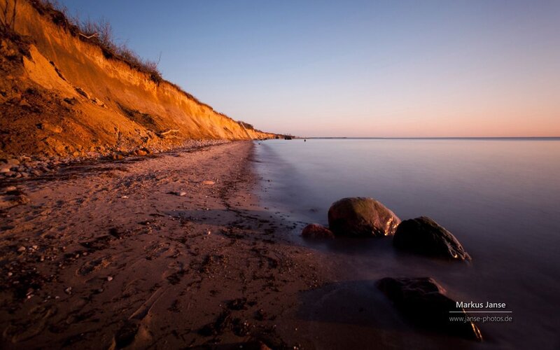 Beach with Cliffs at Sunset — Orange