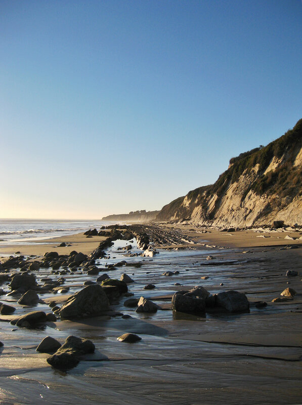 beach with cliffs at sunset