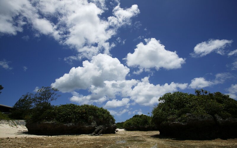 beach with clouds and rocks