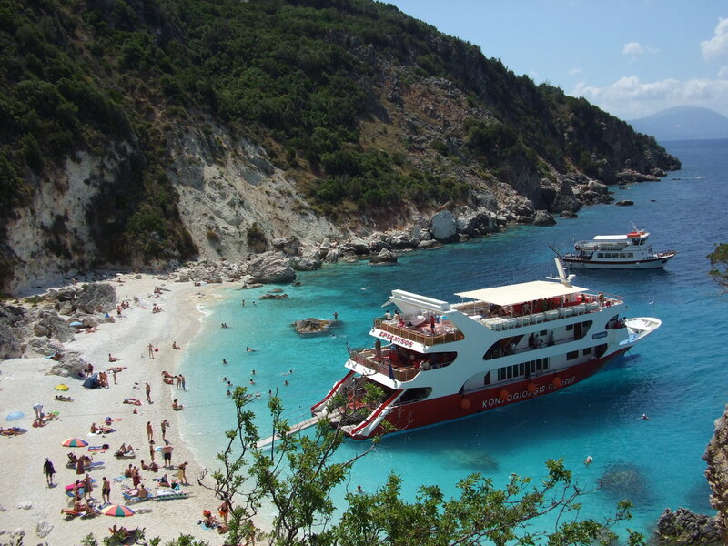 Beach with cruise ship in Greece