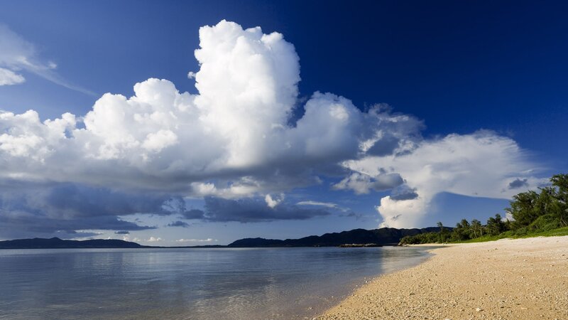 Beach with cumulus clouds