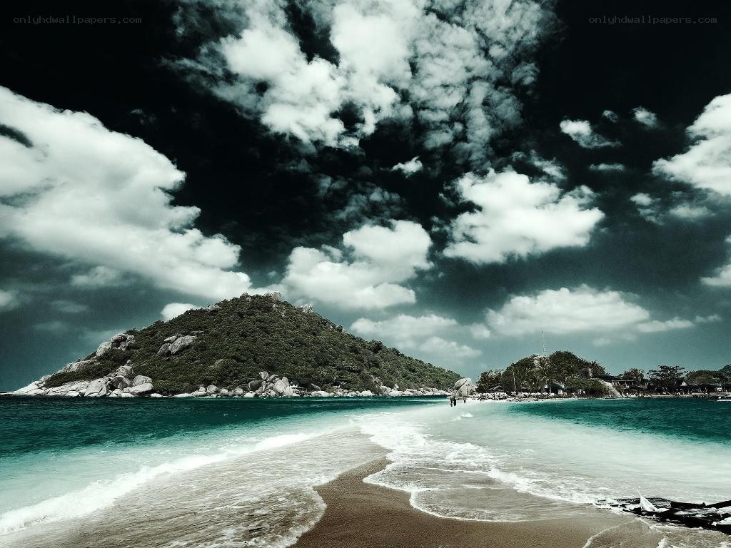 Beach with dramatic sky and island