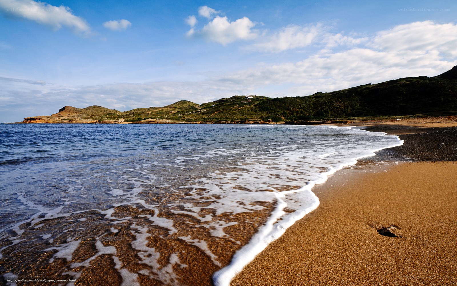 Beach with gentle waves and hills