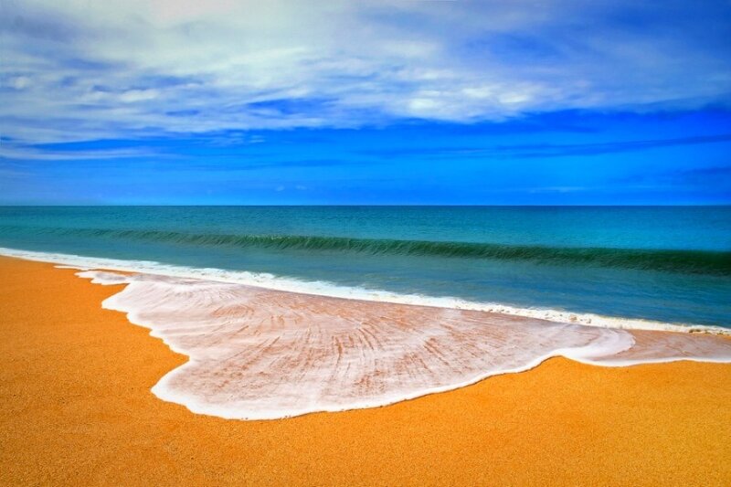 Beach with golden sand and blue ocean