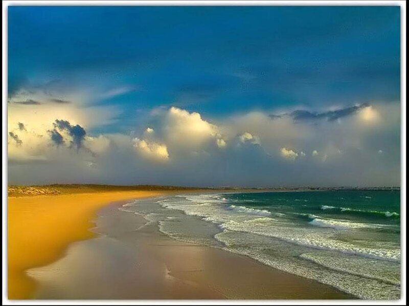 Beach with golden sand and blue sky