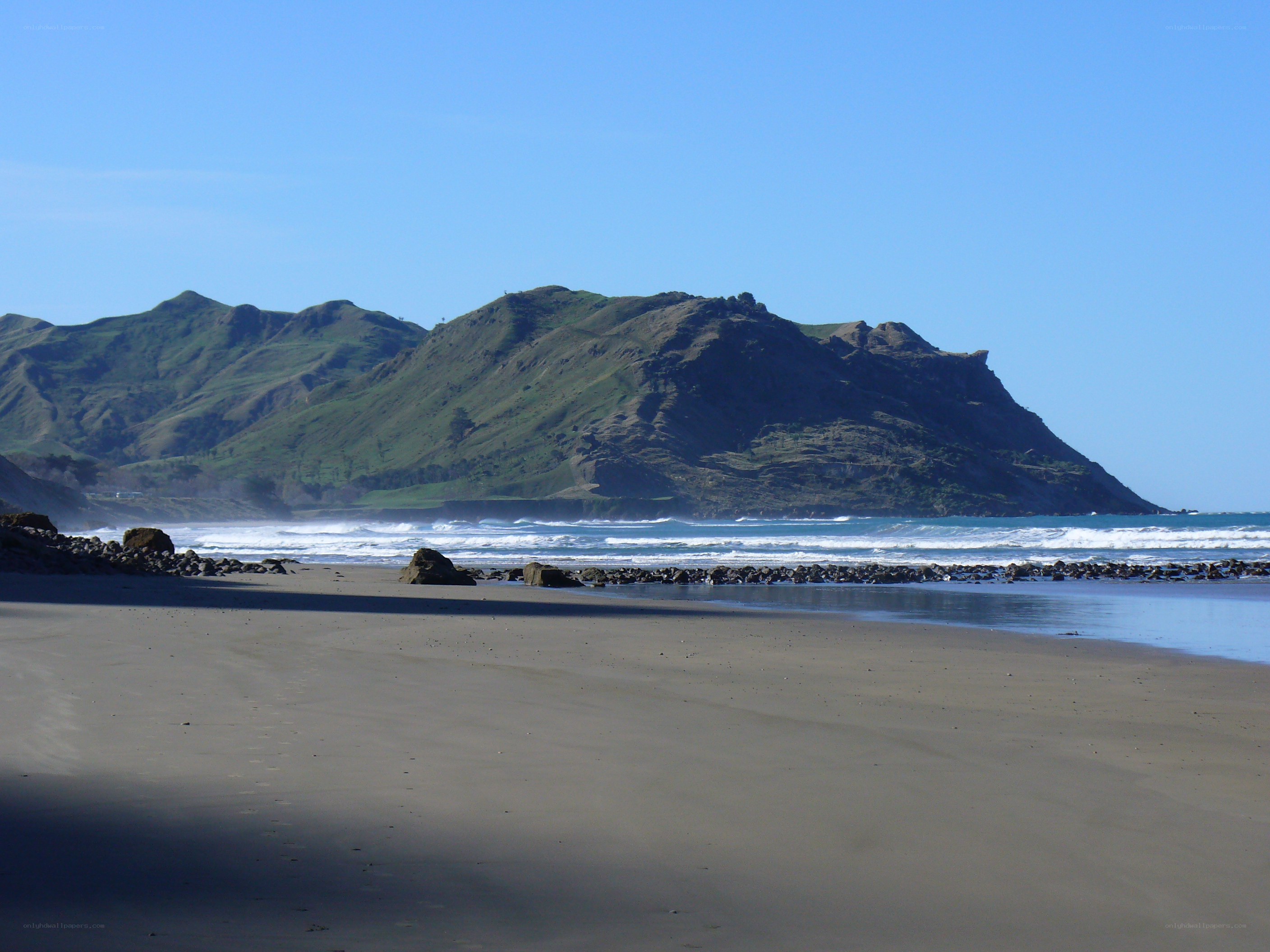 beach with green hills