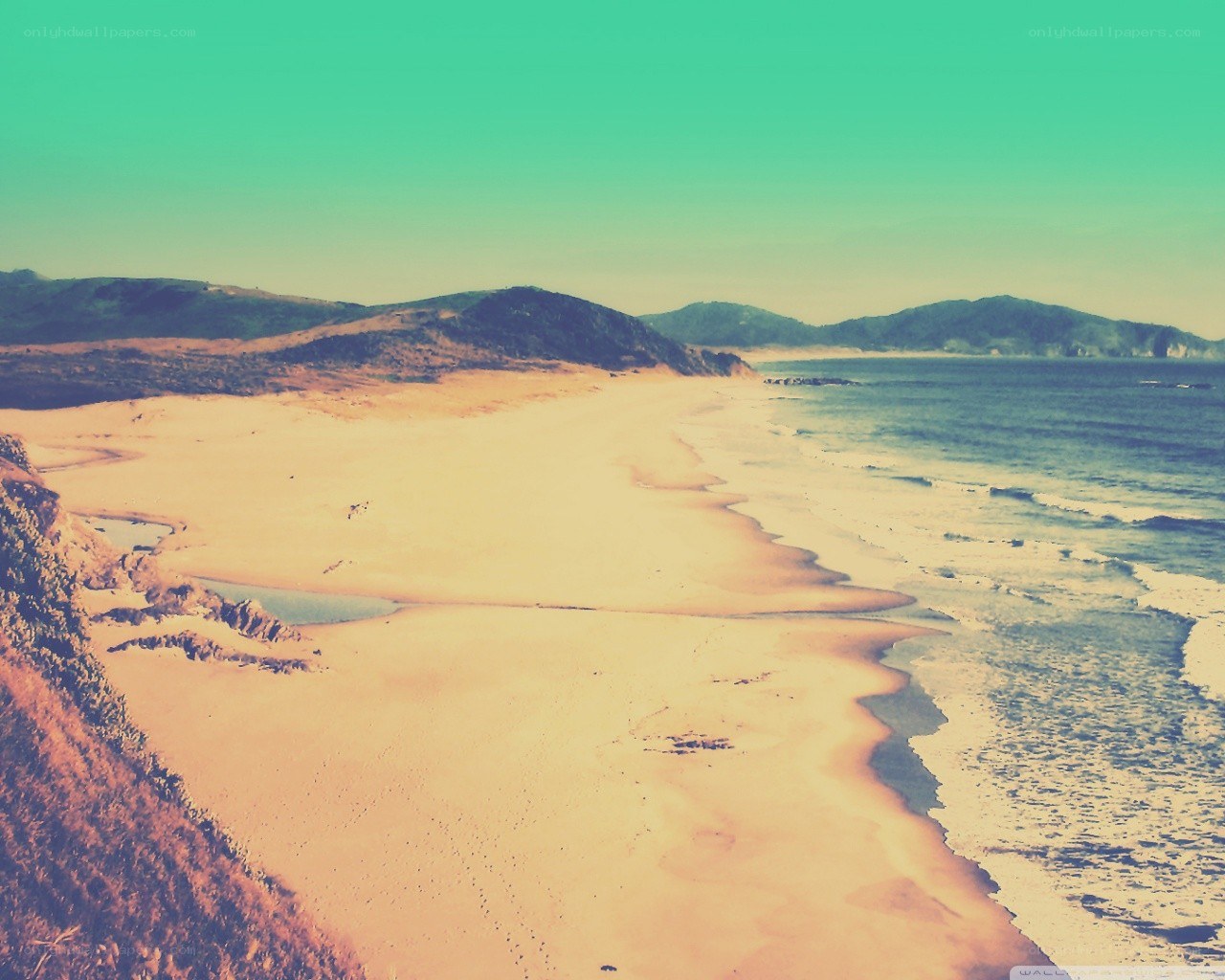 beach with hills and ocean