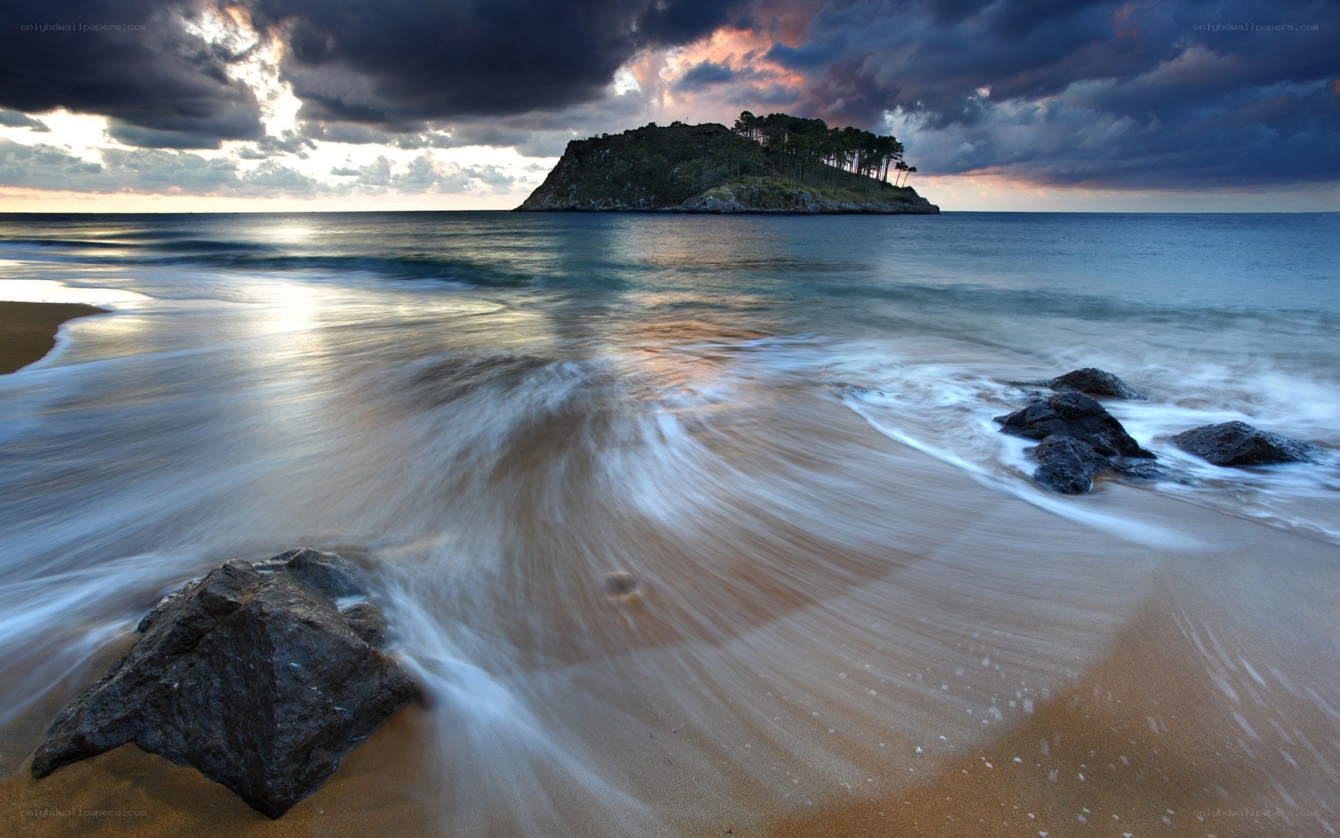 Beach with island at sunset