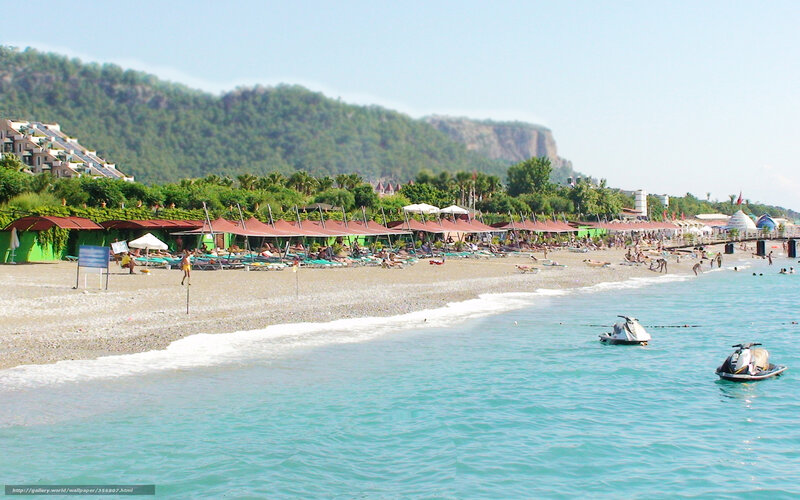 Beach with jet skis and umbrellas