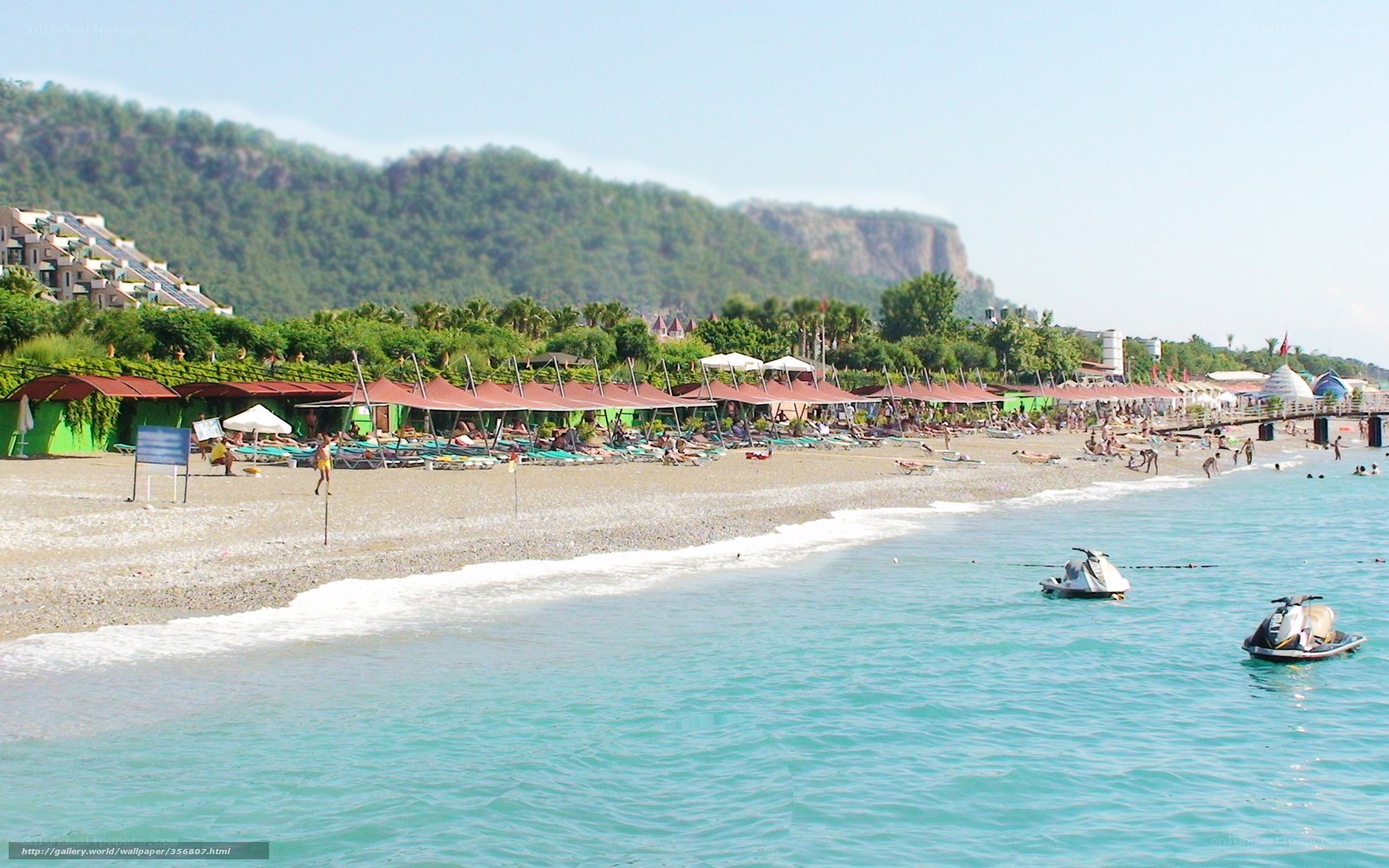 Beach with jet skis and umbrellas