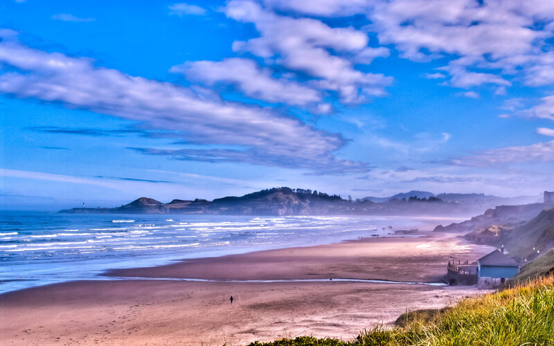 beach with lighthouse and cliffs