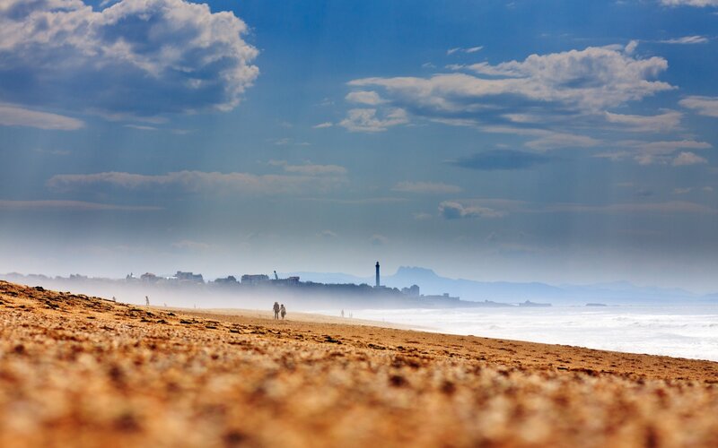 Beach with lighthouse in distance
