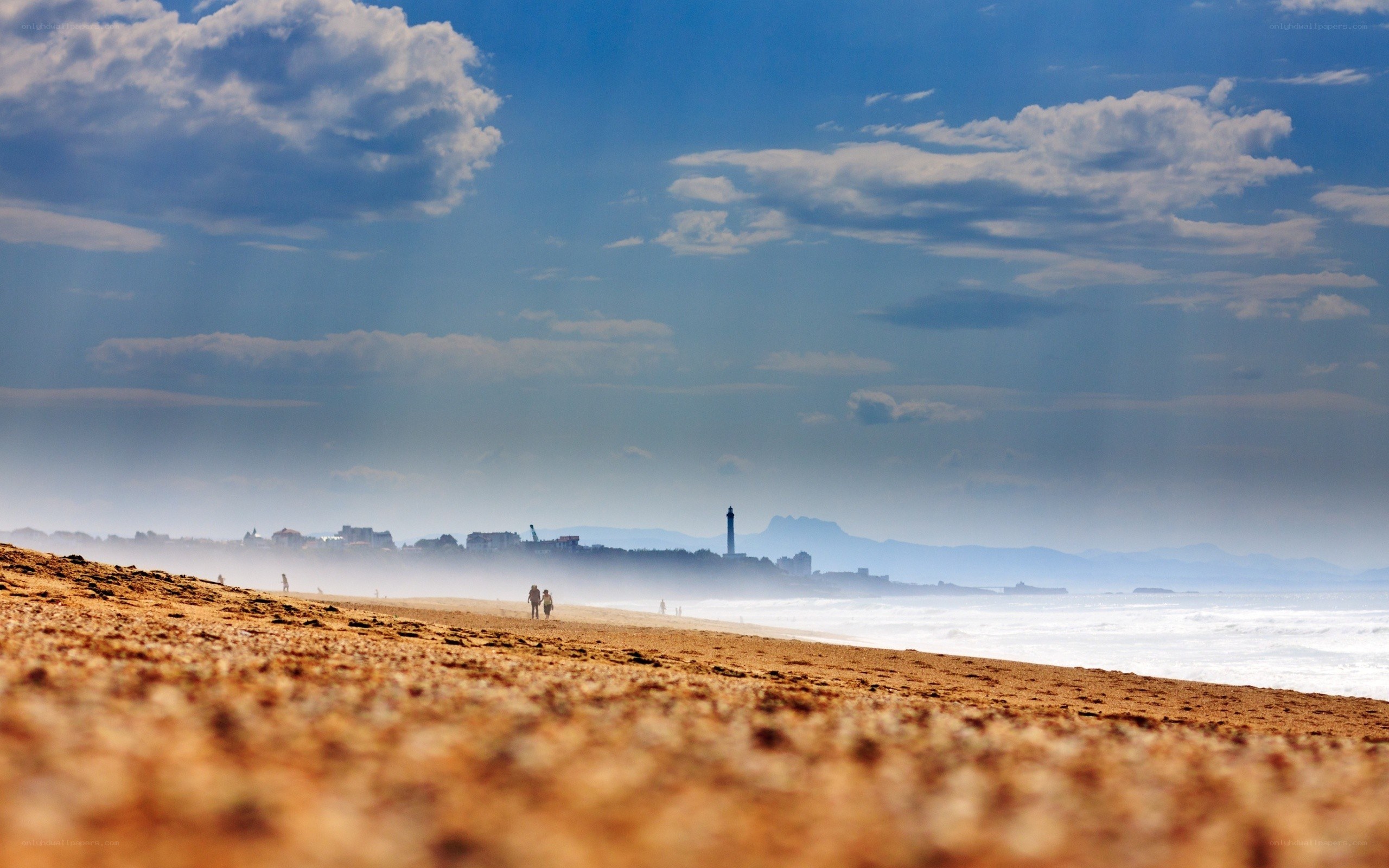 Beach with lighthouse in distance