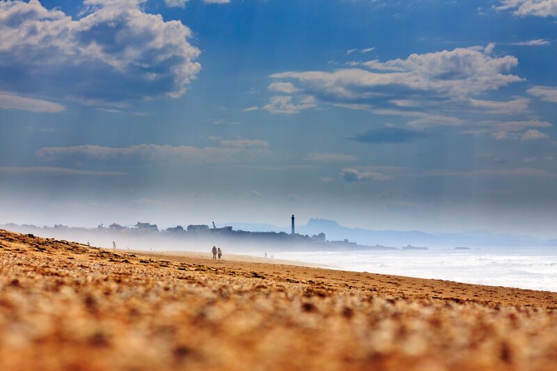 Beach with lighthouse in distance