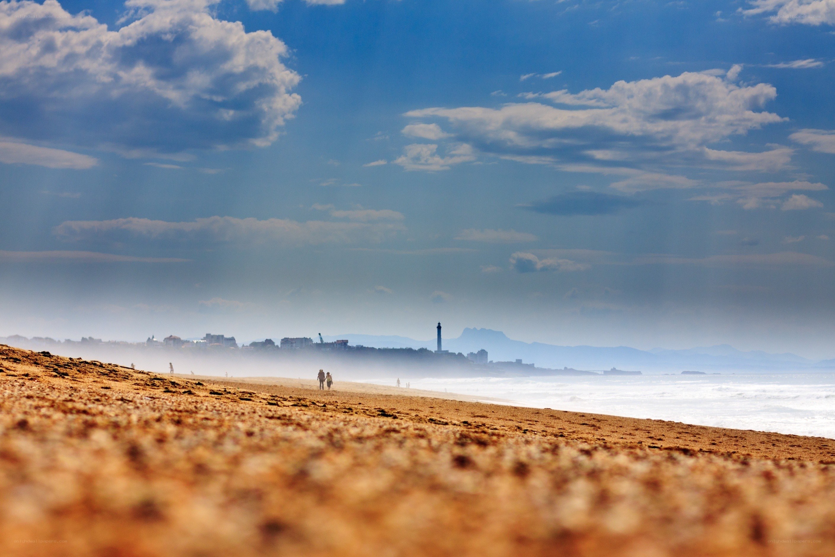 Beach with lighthouse in distance