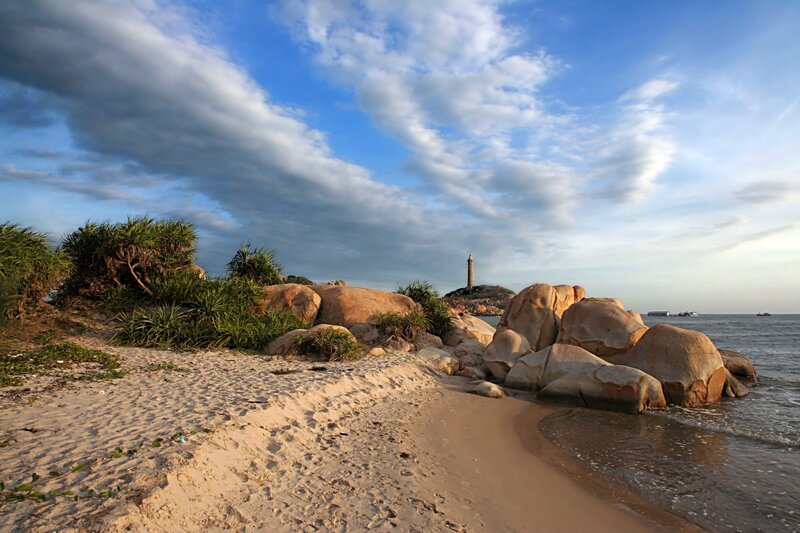 Beach with lighthouse in distance