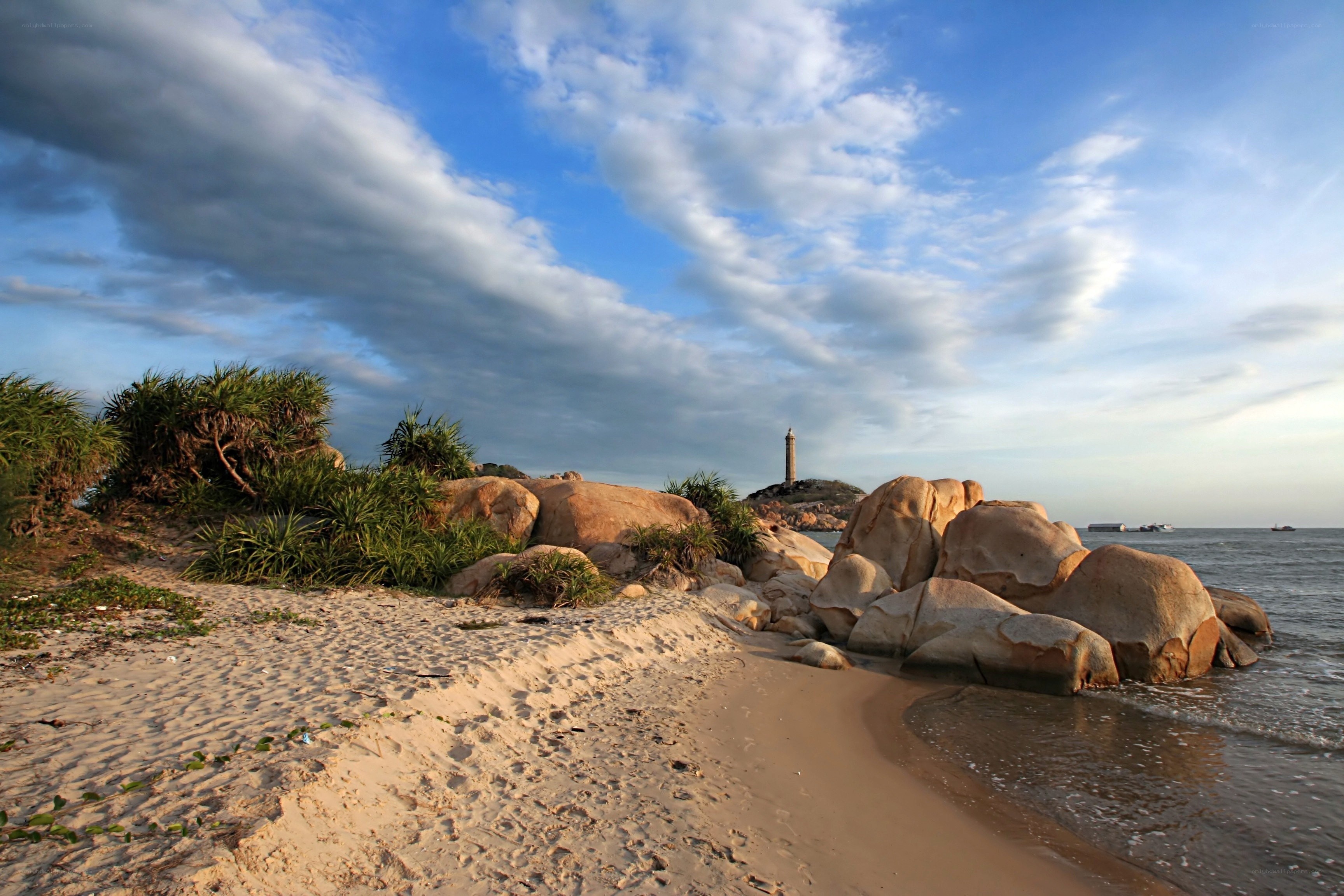 Beach with lighthouse in distance