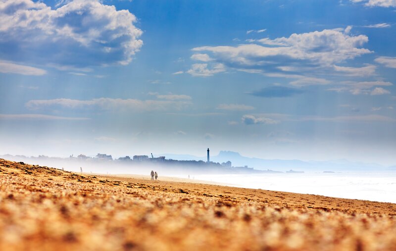Beach with lighthouse in distance
