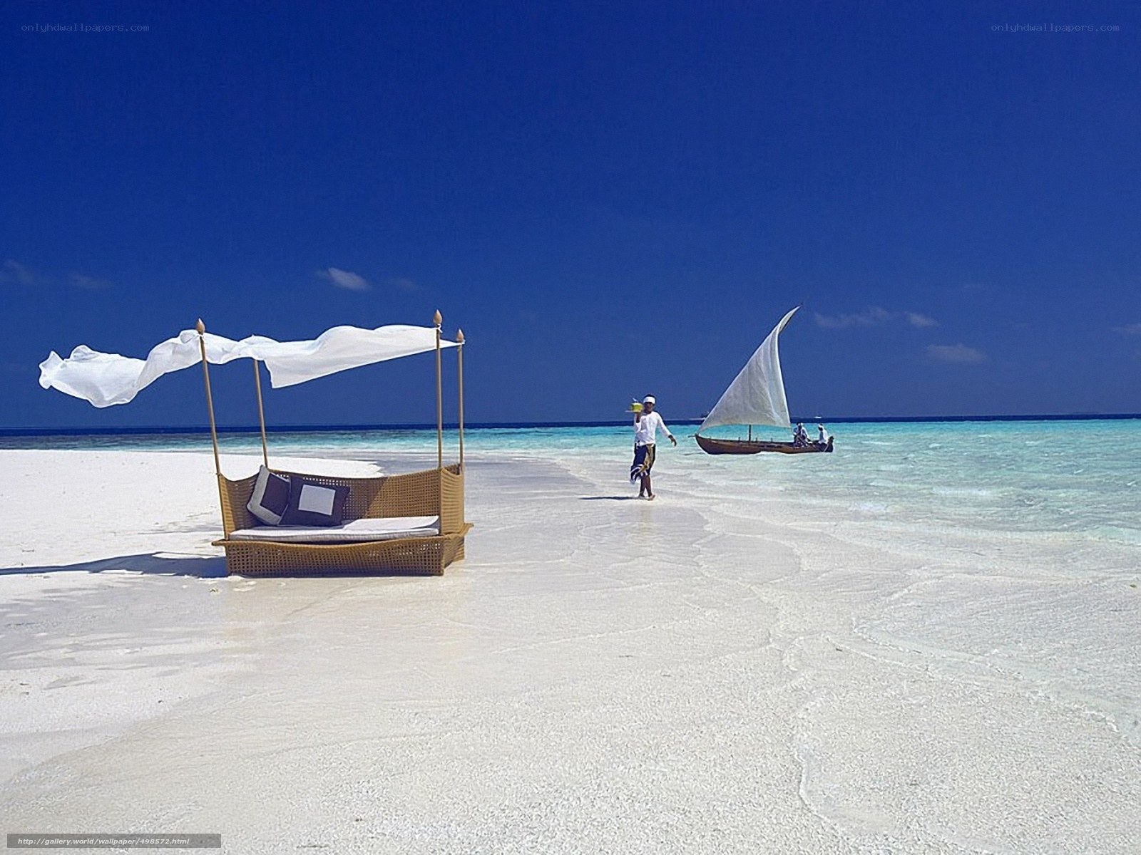 Beach with lounge and sailboat