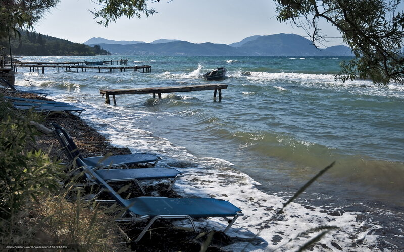 Beach with lounge chairs and boats