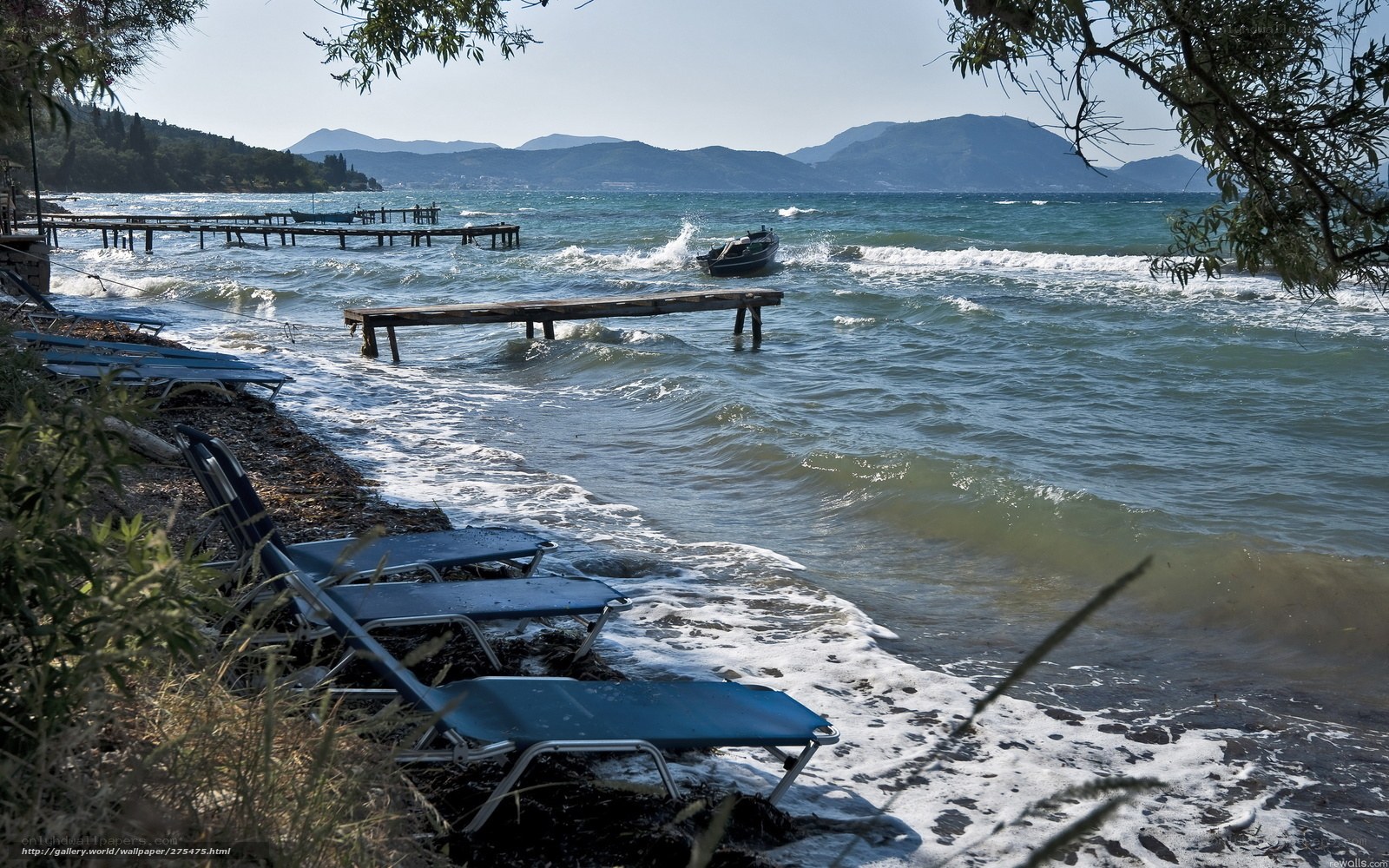 Beach with lounge chairs and boats