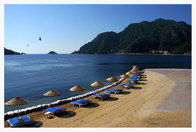 Beach with lounge chairs and mountains