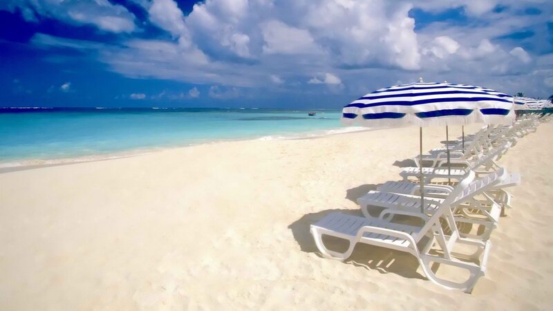 Beach with lounge chairs and umbrellas