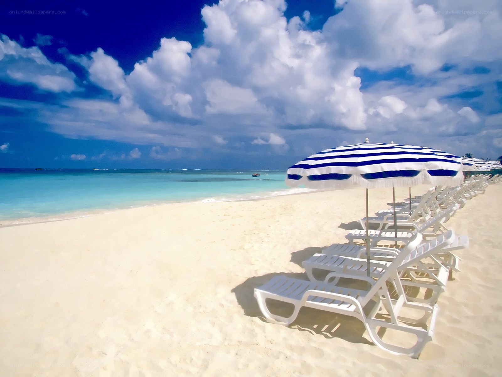 Beach with lounge chairs and umbrellas