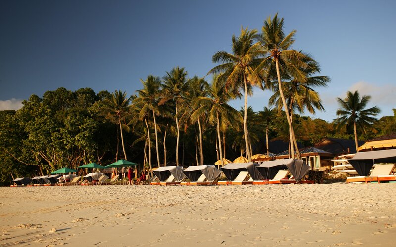 Beach with Lounge Chairs — White, Serene, Sunset